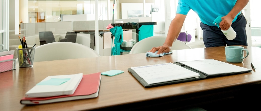 A ServiceMaster expert sanitizing a table during janitorial services in Houston