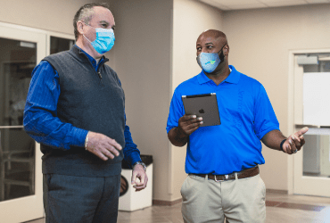 ServiceMaster Clean professional discussing commercial cleaning needs with a client