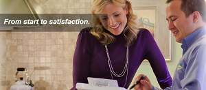 Man and woman smiling looking at paper