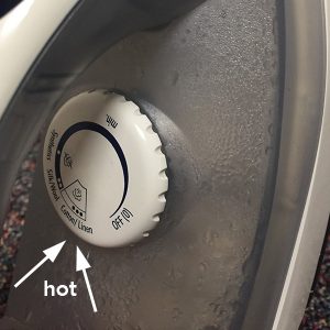 up close image showing how to set iron on high